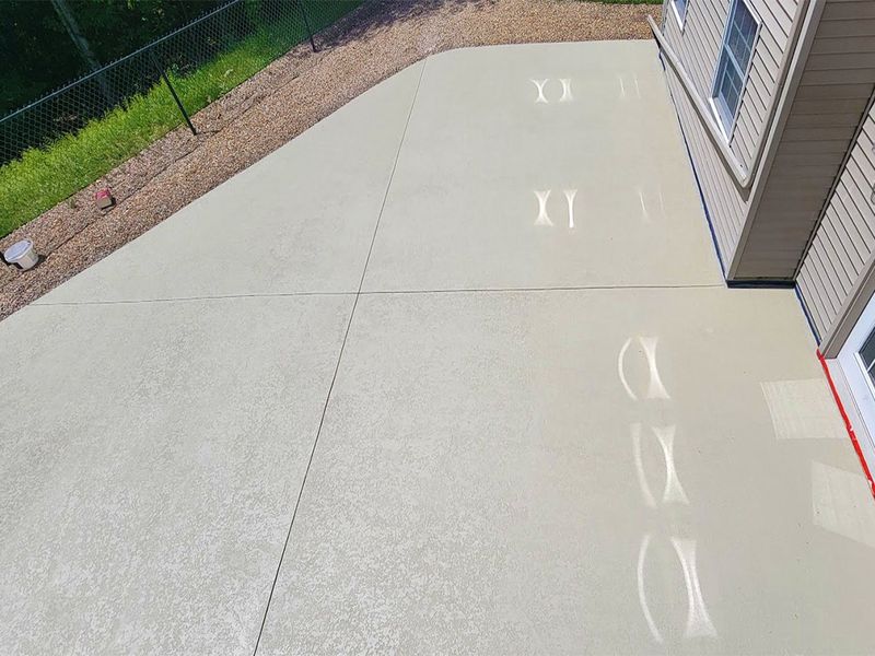 Stamped concrete resurfacing around swimming pool