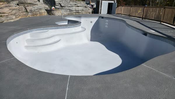 Before: Old pool with blue tile and worn plaster ready for renovation