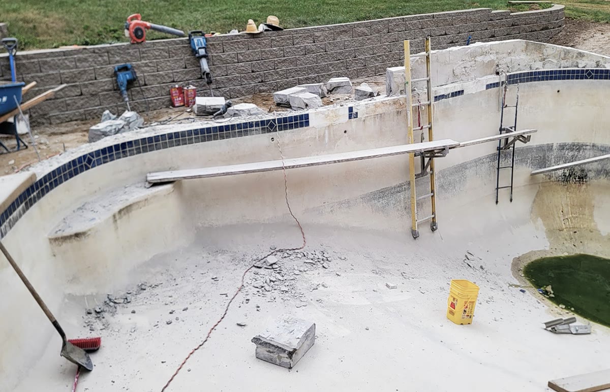 Concrete restoration work on deteriorating pool deck surface